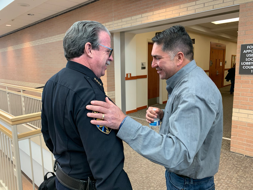Sheriff Tony Spurlock and John Castillo embrace after an arraignment for one of the two suspect in a shooting at STEM School Highlands Ranch, which left Castillo’s son, Kendrick, dead. The younger suspect pleaded guilty in a plea deal on Feb.7.